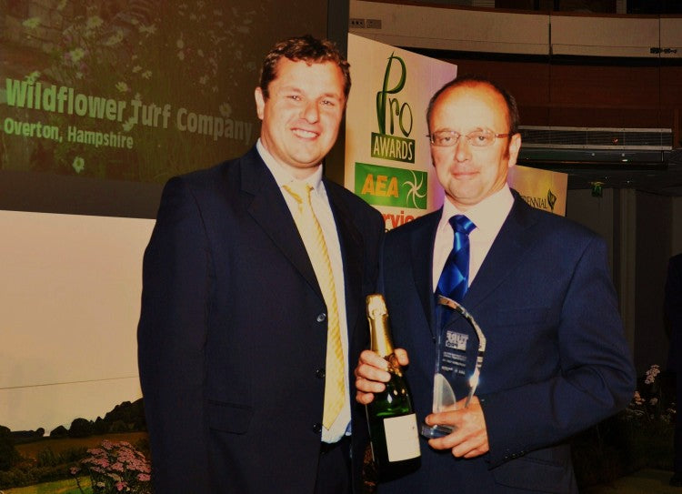 James Hewetson Brown of the Wildflower Turf Company (right) collects the Turf Pro Special Achievement Award from Rupert Price of Ransomes Jacobsen. Pic    Turf Pro