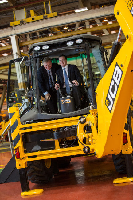 Lord Bamford (left) with the Chancellor in the cab of a JCB backhoe loader