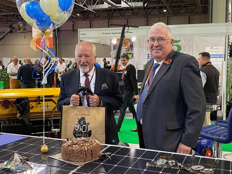 Richard-Campey-presents-Ian-Pogson-with-80th-birthday-gift-at-Saltex-2022.gif